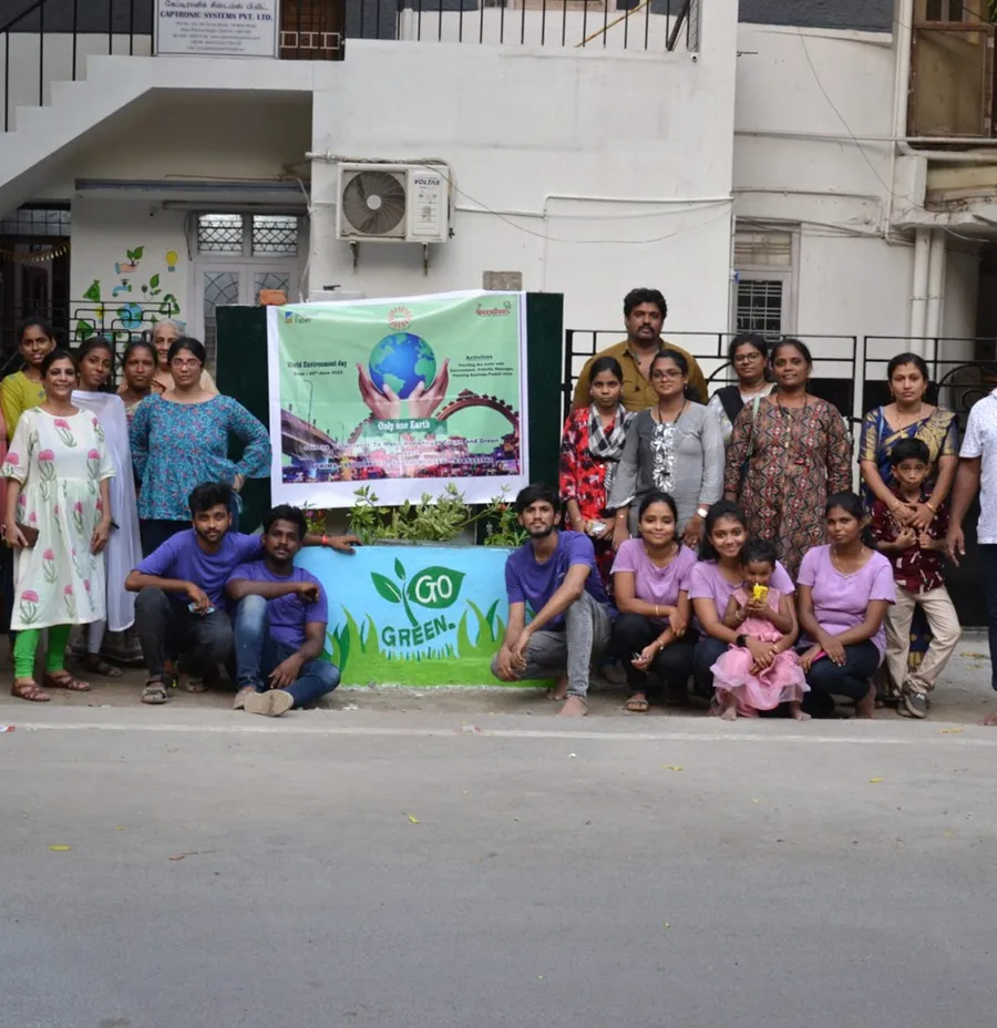 Volunteers with a Go Green banner for the 2023 sustainability project